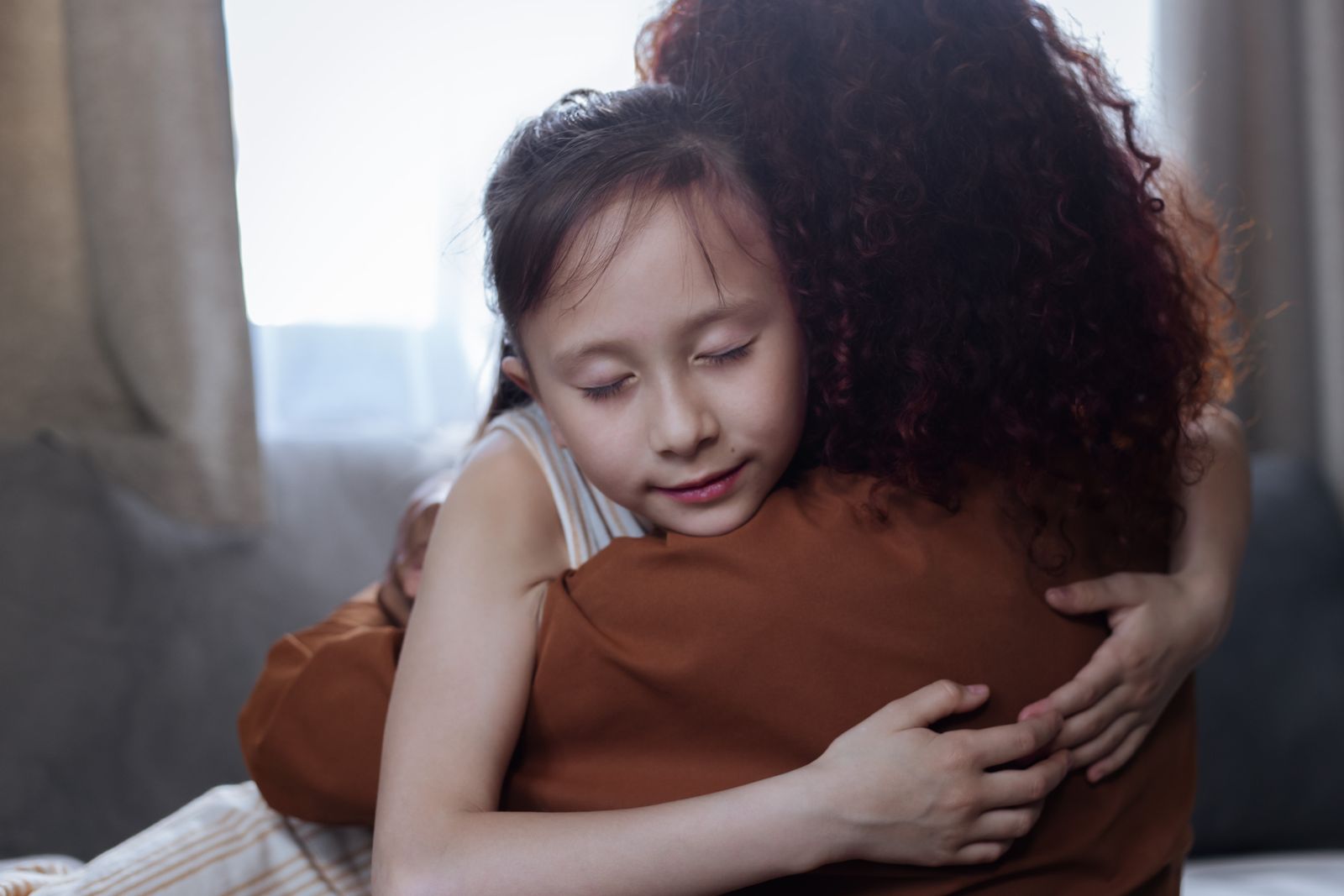 Une mère qui prend sa fille dans ses bras, dans un moment tendre de réconfort